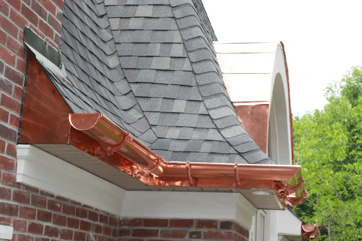 Copper gutter and downspout detail at a roof corner
